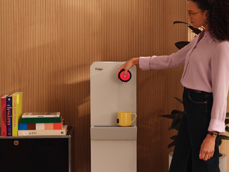 Purity wird im Office von einer Frau bedient, die Heßiwasser zapft